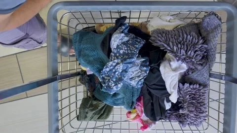 Adding clothes to the laundry cart Video stock 310228618