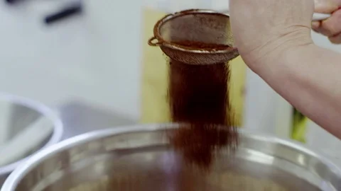Adding the cocoa powder to the flour Stock Footage 72250076