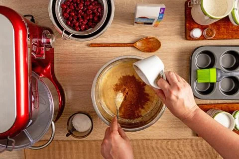 Adding cocoa powder to mixture for muffin making Stock Photos