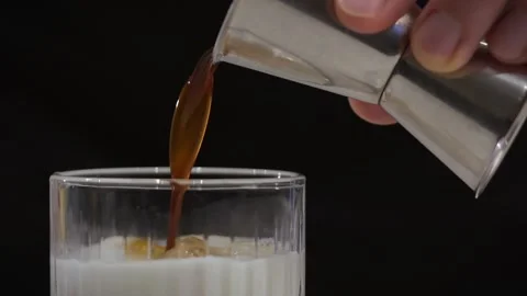 Adding coffee syrup. Adding coffee to ice. White Russian cocktail. Ice coffee. Stock Footage 219564525