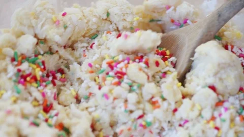 Adding colorful sprinkles to cookie batter Stock Footage 102733546