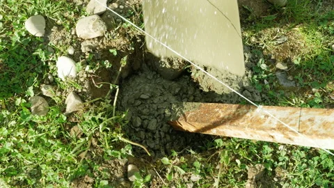 Adding concrete. cementing metallic tube Stock Footage 154408134