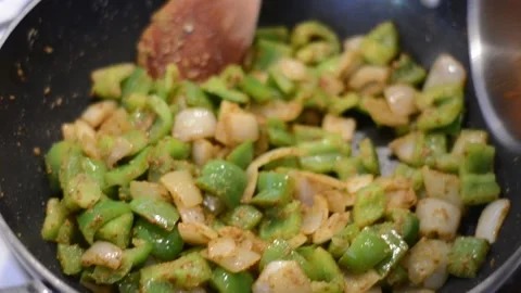 Adding cooked Paneer into the sautee Stock Footage 136059174