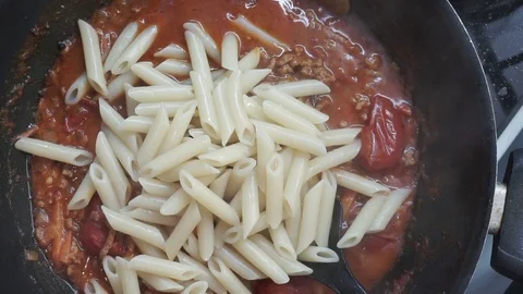 Adding cooked pasta Stock Footage 97410842