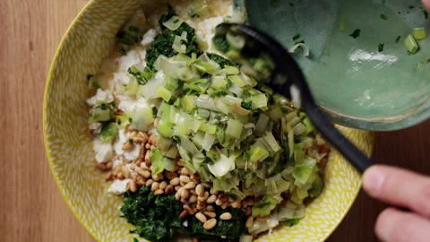 Adding Cooked Vegetables To Spinach Feta Bowl Top View Vidéo 337247086