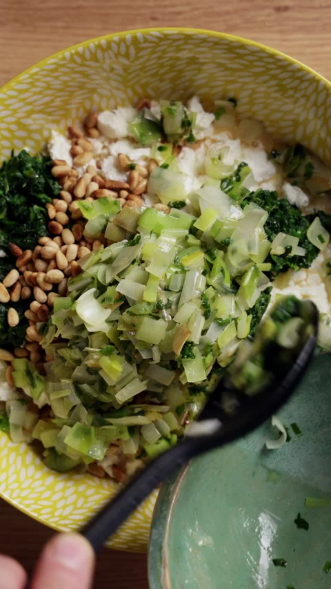 Adding Cooked Vegetables To Spinach Feta Bowl Top View Vertical Видео 337247091