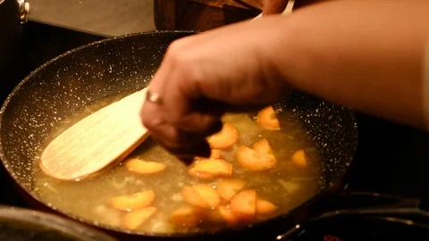 Adding cooking ingredients to hot frying pan which is coming up to boil Stock Footage 93690733