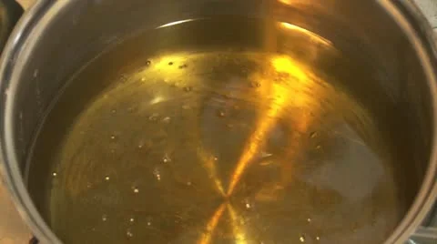 Adding cooking oil to a saucepan Stock Footage 11016374