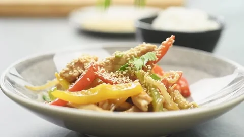 Adding coriander on a stir fry chicken with bell peppers. Stock Footage 162059945