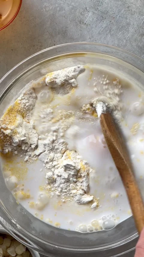 Adding corn to cornbread batter vertical Stock Footage 220803599