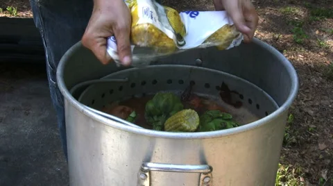 Adding corn to pot Stock Footage 2649867
