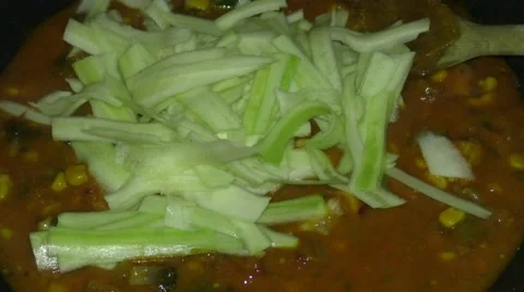 Adding courgette strips Stock Footage 46987438