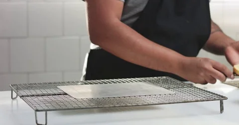 Adding cream and fruit to cake Stock Footage 82993664