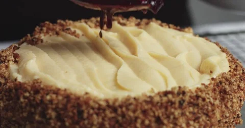 Adding cream and fruit to cake Stock Footage 82993795