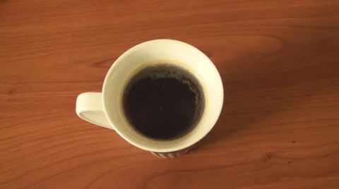 Adding Cream To Black Coffee And Then Mixing Them Down Stock Footage 33660403