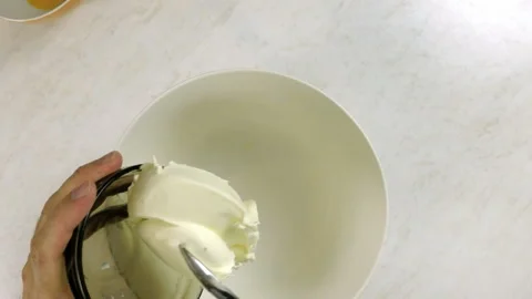 Adding cream cheese in bowl Stock Footage 100232071