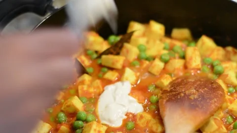 Adding Cream to the Curry Stock Footage 136059167