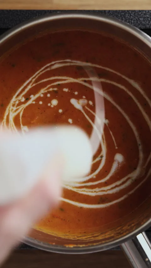 Adding Cream to Tomato Soup in Saucepan Close Up Top View Stockbeeldmateriaal 332358609