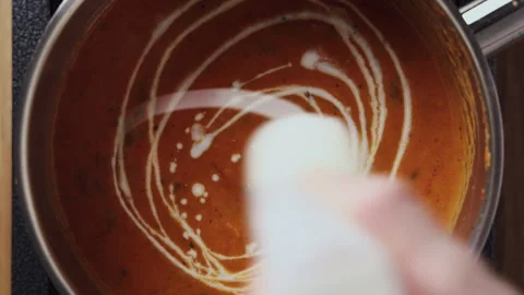 Adding Cream to Tomato Soup in Saucepan Close Up Top View Horizontal Vídeos de archivo 332548847