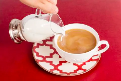 Adding creamer to coffee Stock Photos