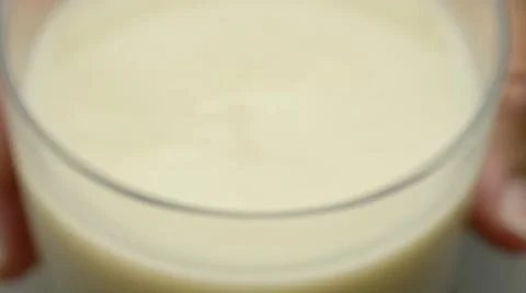 Adding creamy oat milk liquid to bowl of wet and dry flour baking ingredients Stock Footage 61846802