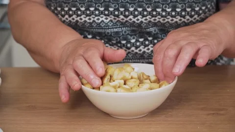 Adding crispy croutons into bowl for Caesar salad. Mixing toasted bread cubes Stock Footage 333314121