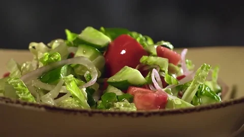 Adding crumb of walnut to dressed prepared organic salad with fresh vegetables Stock Footage 76963798