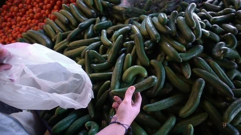 Adding Cucumber to Nylon Pochette Stock Footage 106222156