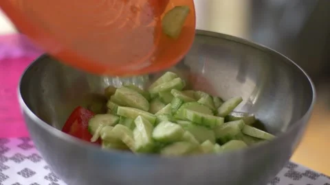 Adding cucumber to a salad Stock Footage 142190165