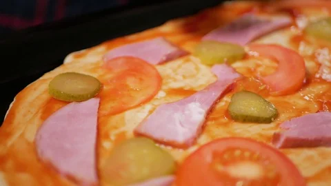 Adding cucumbers on pizza, close up Stock Footage 128667571