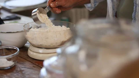 Adding a Cup of Flour to Measuring Bowl, HD Stock Footage 148191197