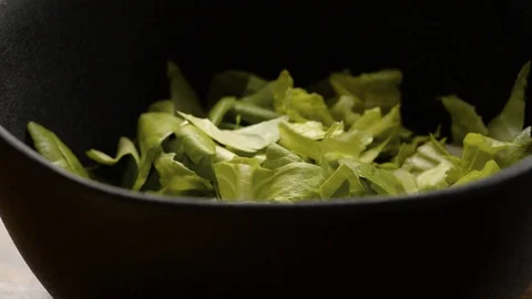 Adding Cut Butter Lettuce into half empty Salad bowl Stock Footage 116787259