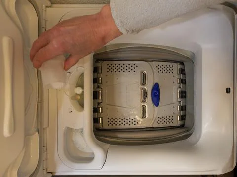 Adding detergent into washing machine compartment before laundry Stock Photos