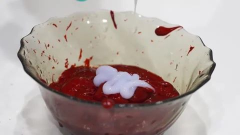 Adding developer to red hair dye for vibrant color Stock Footage 337241824