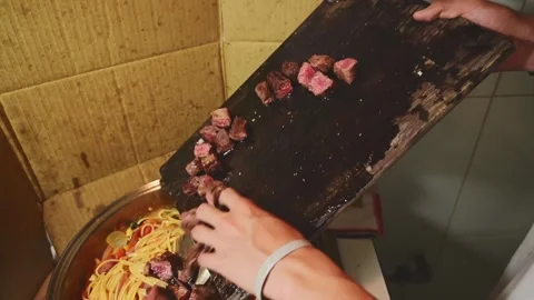Adding Diced Beef to Pasta with Tomato Sauce During Final Cooking Process Stock Footage 340956174