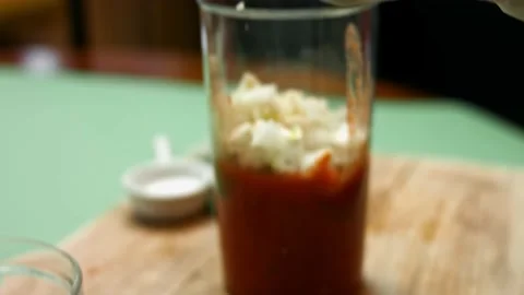 Adding diced chili pepper to chopped tomatoes into hand blender glass. Process Stock Footage 151172871