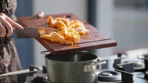 Adding Diced Sweet Potato into Cooking Pot Stock Footage 336466798