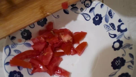 Adding Diced Tomato to Plate, Hand Serving Fresh Tomato, Preparing Meal with Stock Footage 315193943