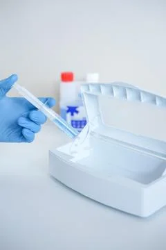 Adding disinfectant solution to a sterilizer Stock Photos