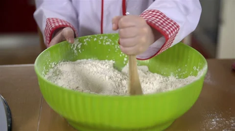Adding egg to bowl with flour Video stock 34431385