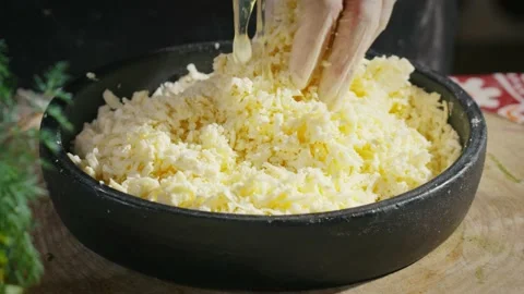 Adding an egg to cheese mixture for Khachapuri Stock Footage 138127528