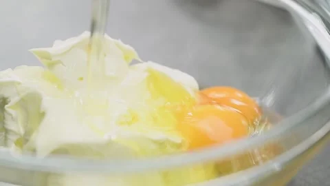 Adding egg to cream cheese in the glass bowl. Stock Footage 161016768
