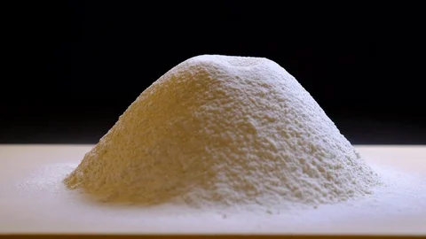 Adding an egg into flour Stock Footage 100259111