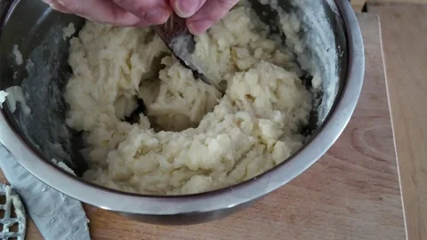 Adding egg to homemade mashed potatoes 스톡 동영상 347018375