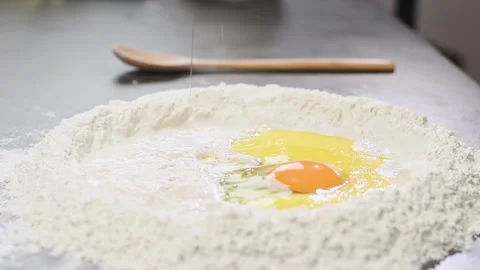 Adding egg to the mixture . Process of making dough. Stock Footage 152519055