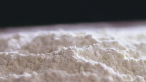 Adding an egg to the wheat flour Stock Footage 75894061