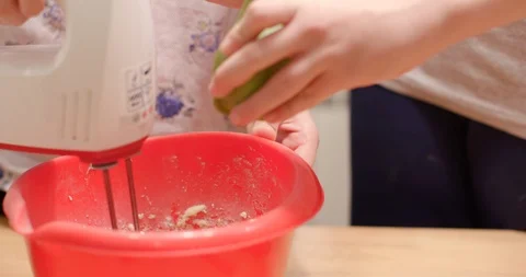 Adding egg white to dough in mixing bowl Stock Footage 105786886
