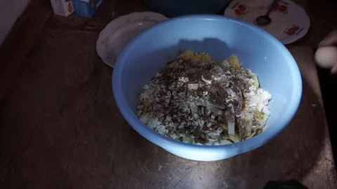 Adding egg white to meat and potato mixture Stock Footage 106197241