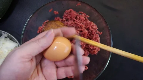 Adding eggs and vegetables overhead Stock Footage 119780928