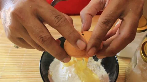 Adding eggs to the dough. cooking recipes Stock Footage 334647277